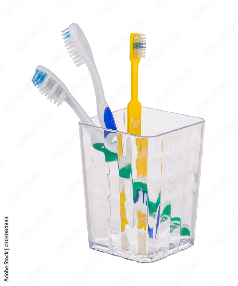 toothbrushes in a glass toothbrushes in a glass