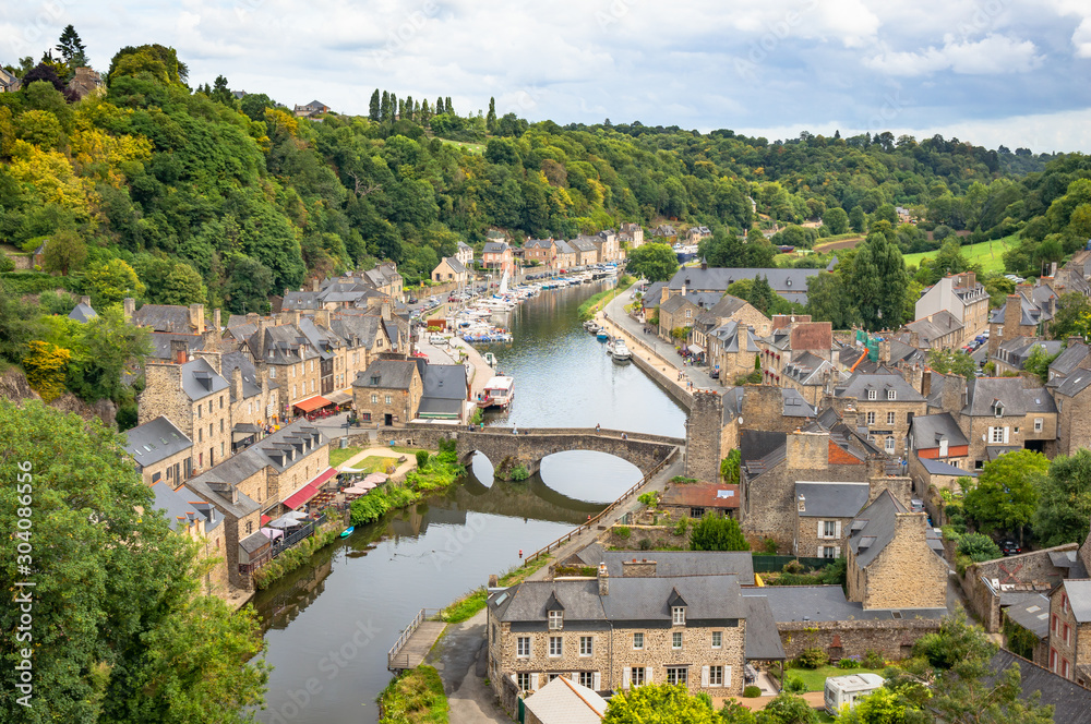 Beautiful aerial view of the historic town of Dinan with Rance river on a sunny day with dramatic cloudscape in summer, Cotes-d'Armor department, Bretagne, northwestern France