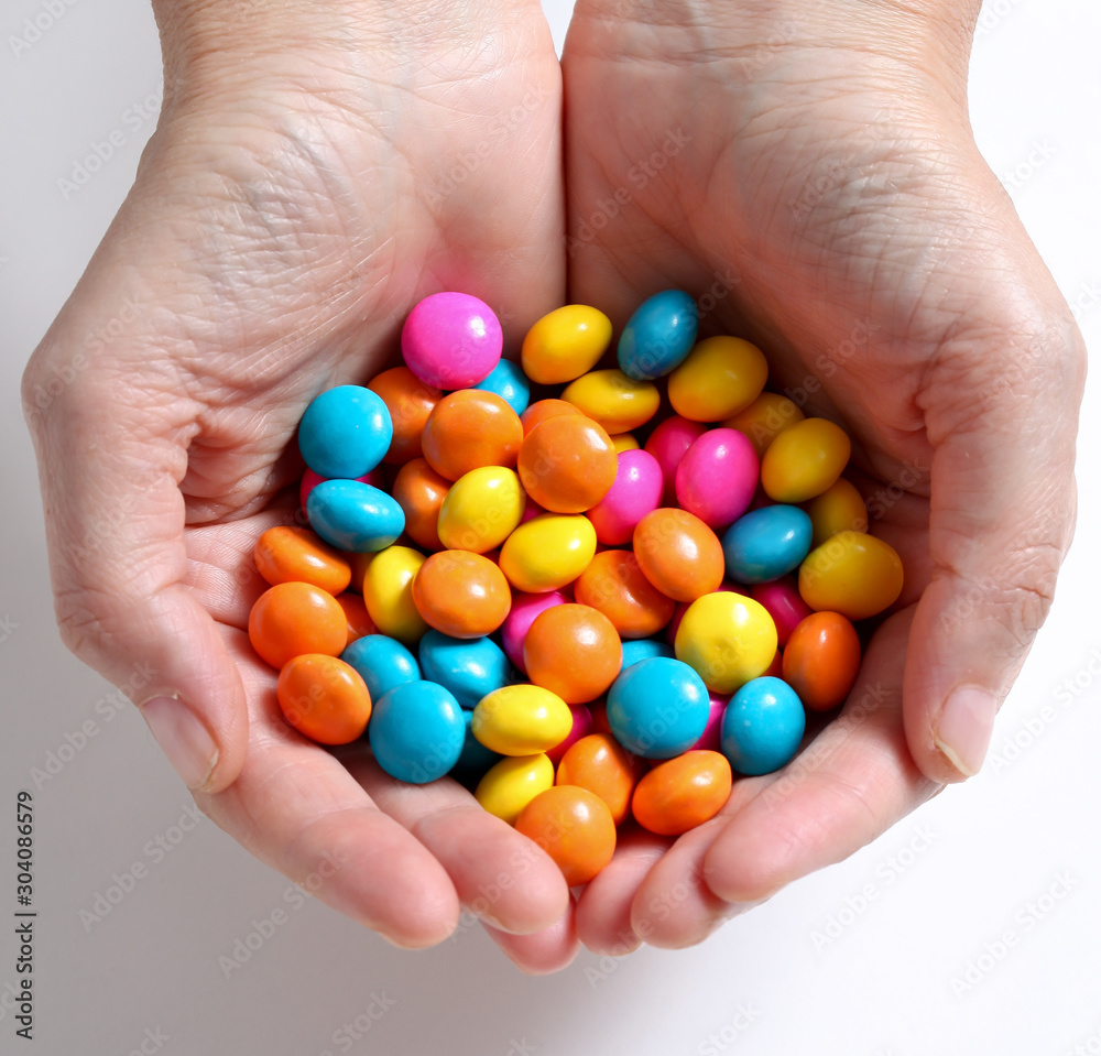 Hands with sweet colorful candy Hands with sweet colorful candy