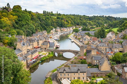 Beautiful aerial view of the historic town of Dinan with Rance river on a sunny day with dramatic cloudscape in summer, Cotes-d'Armor department, Bretagne, northwestern France