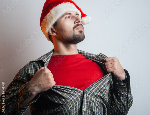 A young man turns into Santa Claus. Santa rips the shirt on his chest like a super hero