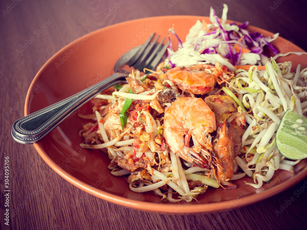 Thai Fried Noodles with shrimp and vegetables ,Pad Thai On a wooden table background Thai Fried Noodles with shrimp and vegetables ,Pad Thai On a wooden table background