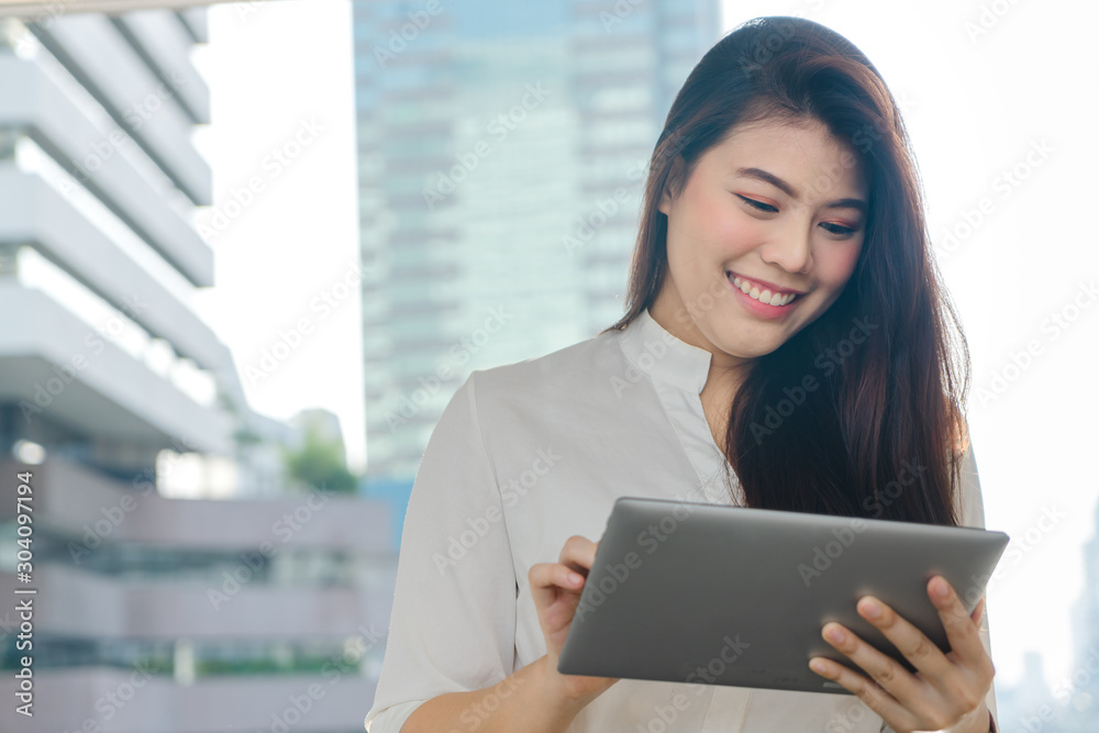 Professional business woman smiling use tablet looking working to outdoor city. Professional business woman smiling use tablet looking working to outdoor city.