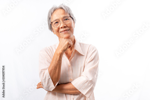 Asian  senior woman smiling with hand touching chin studio shot isolated on white background