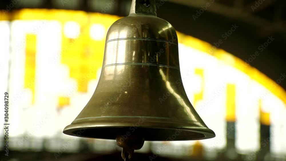 Bell at train station, An announcer rings the bell during train departing from train station.