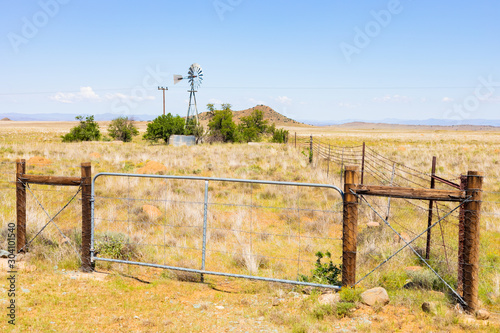 Canvas Print Windmill on a farm in rural grassland area of South Africa