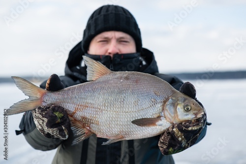 Winter fishing. The happy smiling angler with bream