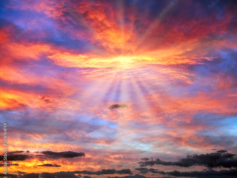 Cloudy Sunrise Sky in Blue, Red, Orange, Yellow with Sun Rays - obrazy, fototapety, plakaty 