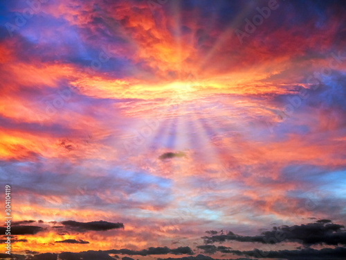 Cloudy Sunrise Sky in Blue, Red, Orange, Yellow with Sun Rays