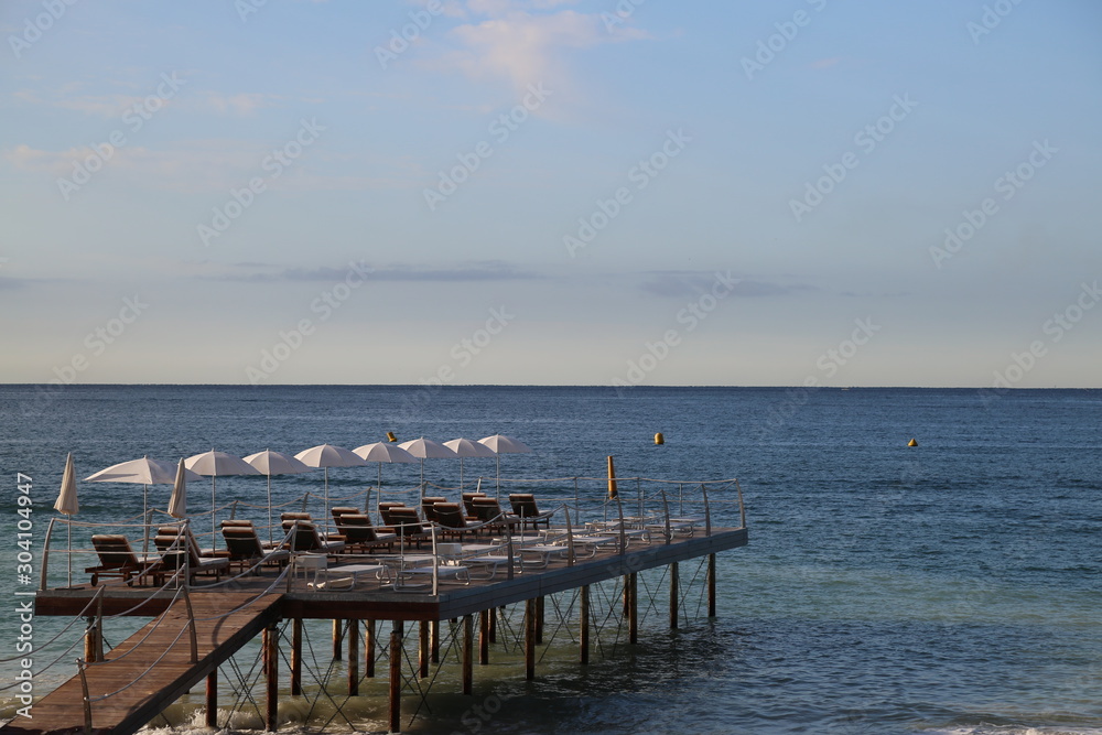 A pier with parasols and loungers in Cannes