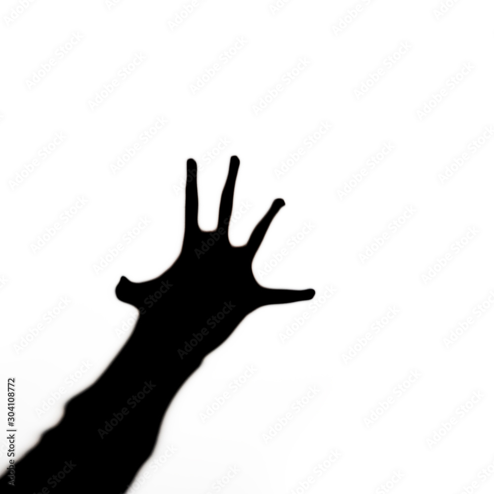 Obraz premium Black silhouette of human hand with spread fingers stretches like in horrors