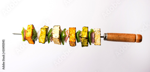 Flying Paneer Tikka isolated over white or black background, selective focus