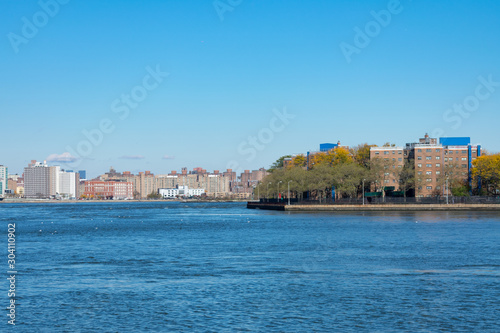 Fototapeta Naklejka Na Ścianę i Meble -  Shoreline of Astoria Queens New York with the East River and the Shore of Manhattan
