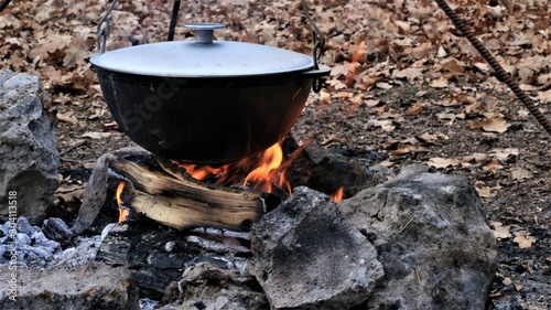 food in the cauldron on the fire in the forest