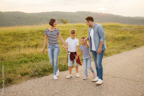Shot of a family of four enjoying a sunny day in the nature