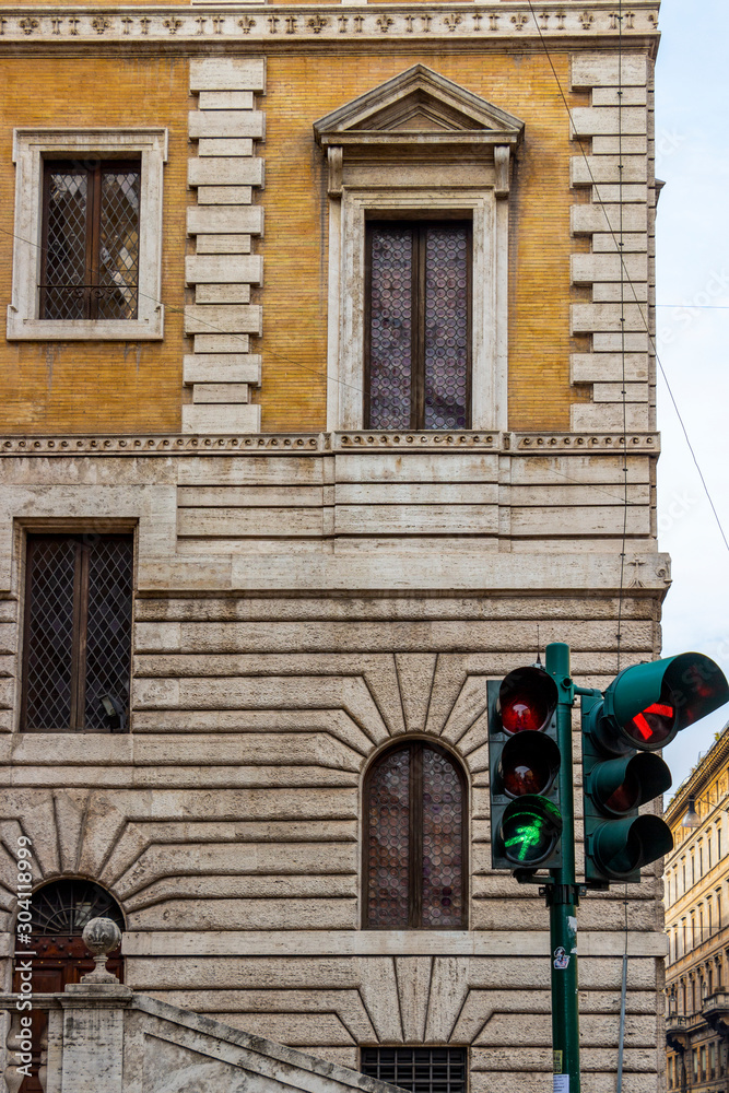Obraz premium Traffic lights in front of the The Piccola Farnesina, seat of Museo Barracco di Scultura Antica or Barracco Museum of Antique Sculpture in Rome, Italy 