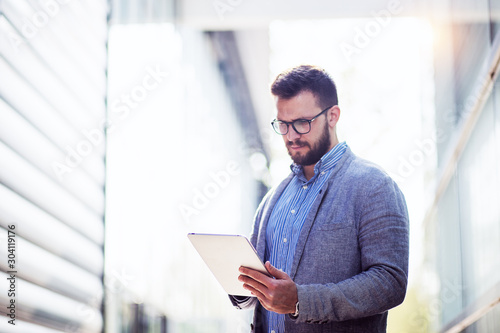 Portrait of businessman with digital tablet