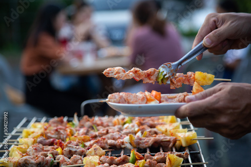 Barbeque Grill Street Food in thailand,Eat outdoors in a happy family. holiday celebration concept