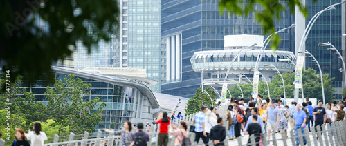 Photography (Focus on the background) Defocused crowd of local people and tourists walking on a bridge in Singapore