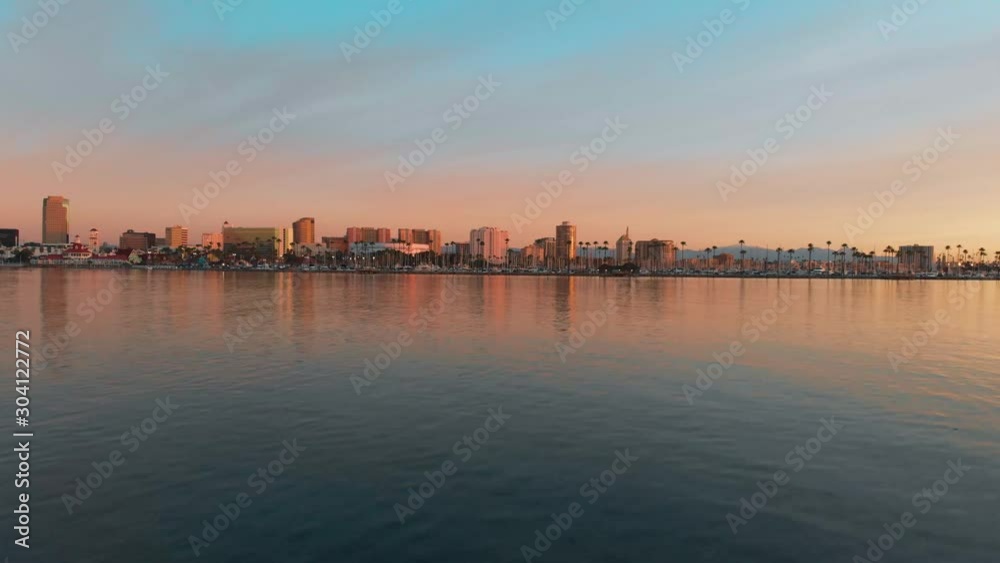 Drone flying over water towards Long Beach California