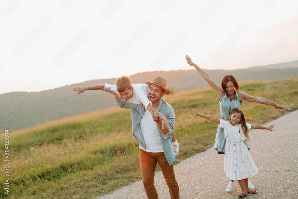 Happy smiling family spending summer day at park. Happy smiling family spending summer day at park.
