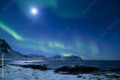 Beautiful northern lights over the snow covered winter landscape of the Lofoten islands