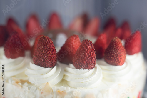 Fototapeta Fresh strawberry topping over whipping cream on cake