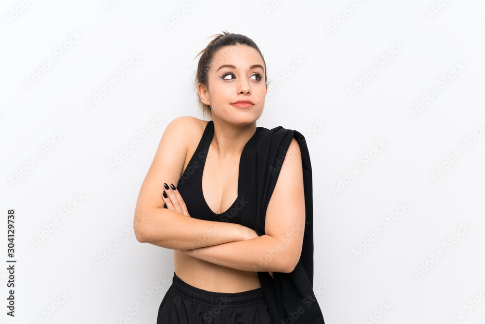 Young sport woman over white wall making doubts gesture while lifting the shoulders Young sport woman over white wall making doubts gesture while lifting the shoulders