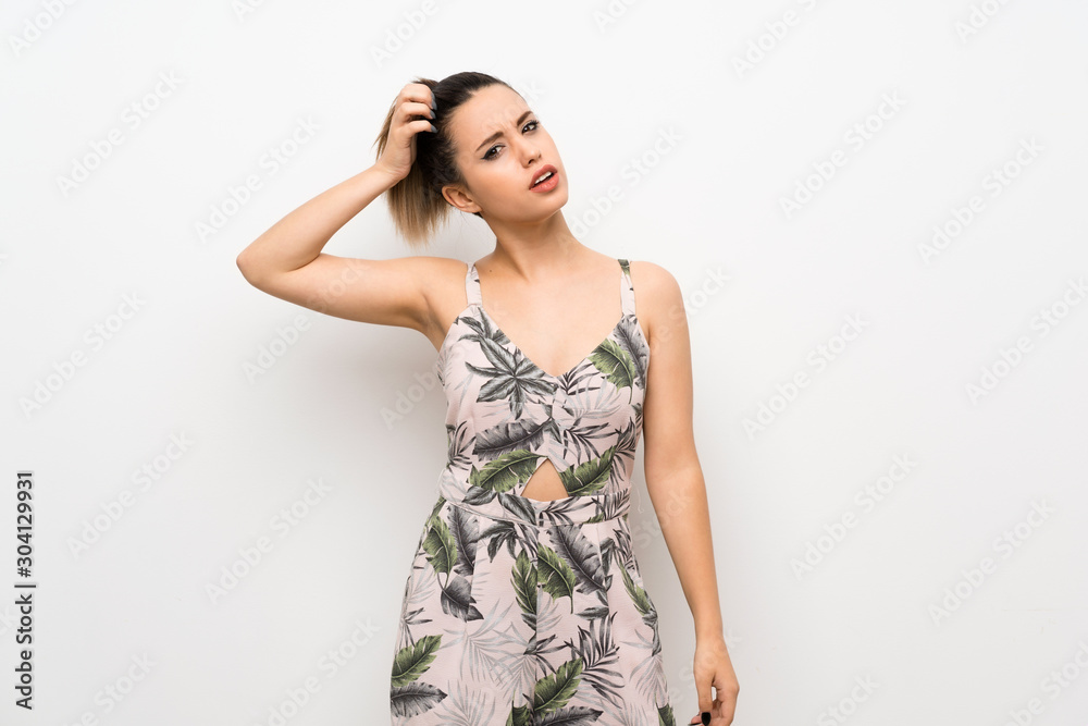 Young woman over isolated white background having doubts while scratching head Young woman over isolated white background having doubts while scratching head