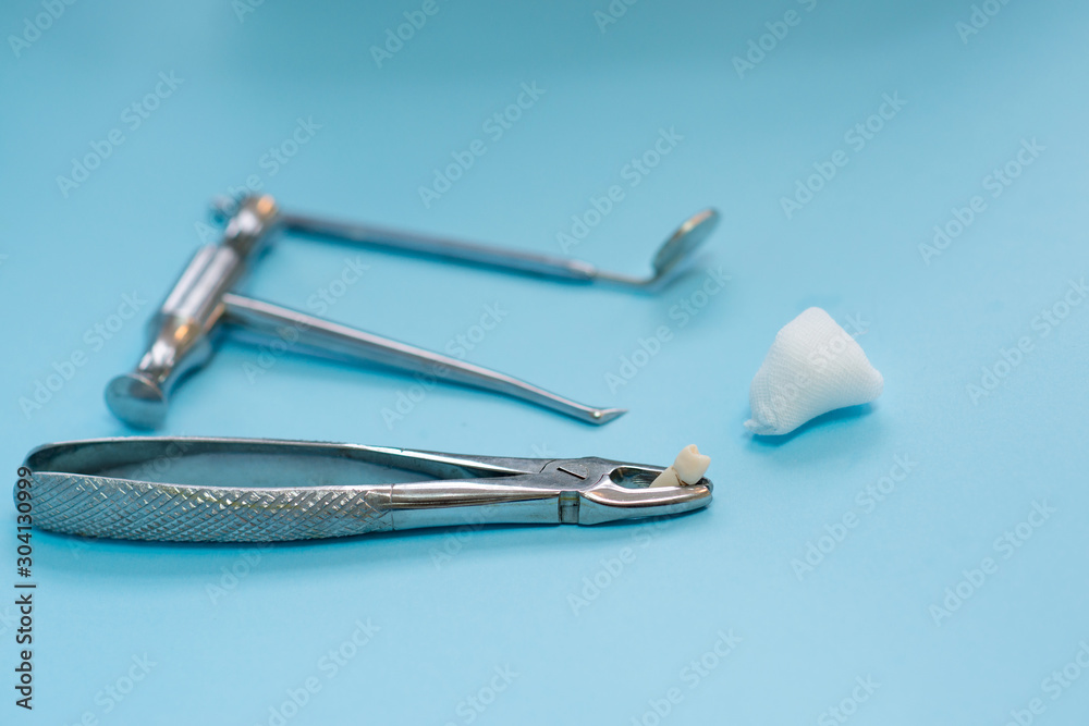 extraction of a diseased tooth, tools of a stamotologist in a stomatologist’s office for dental treatment of caries extraction of a diseased tooth, tools of a stamotologist in a stomatologist’s office for dental treatment of caries