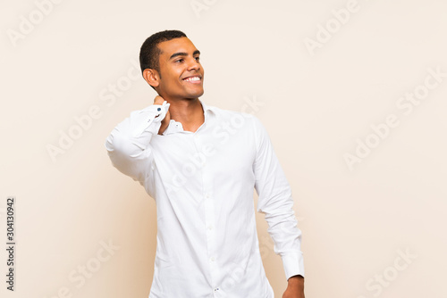 Young handsome brunette man over isolated background thinking an idea