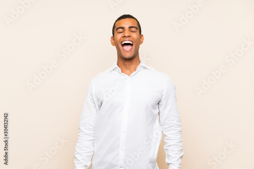 Young handsome brunette man over isolated background shouting to the front with mouth wide open © luismolinero