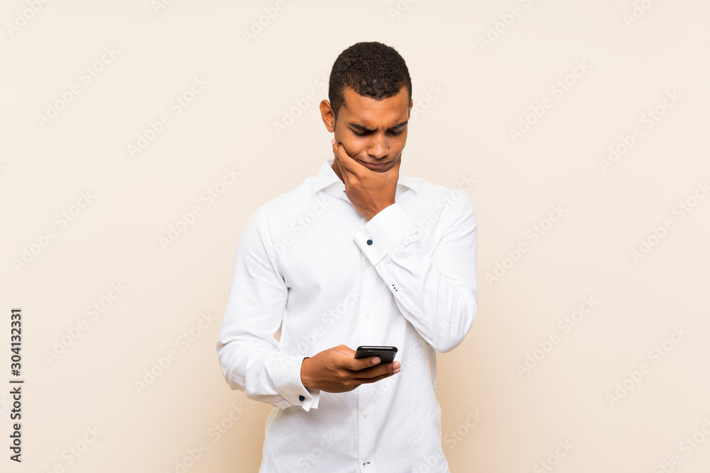 Young handsome brunette man over isolated background thinking and sending a message Young handsome brunette man over isolated background thinking and sending a message