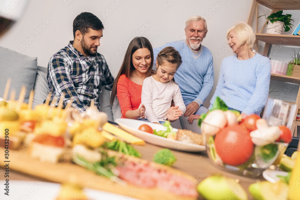 Family after dinner plays with the child and rests