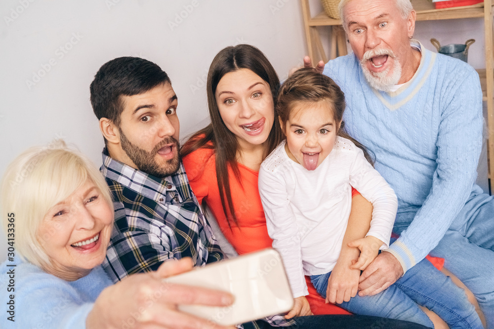 Funny family making selfie at smart phone