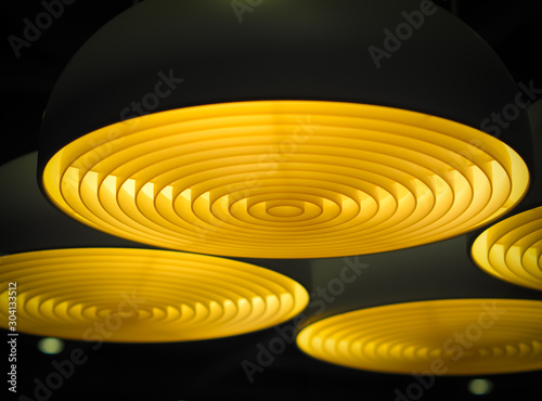 Selective focus of geometric circular ceiling lights in the dark. Abstract background.