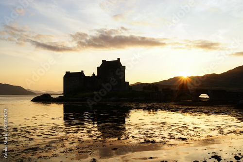 The silhouette of the Eilean Donan Castle during sunset
