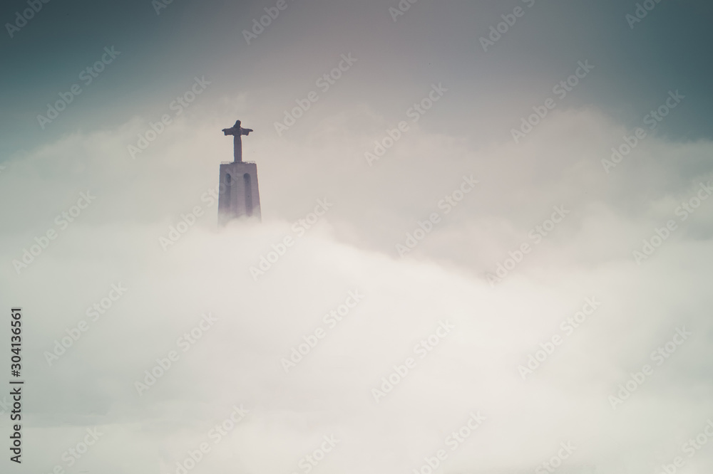 Jesus Christ statue above the clouds in Lisbon, Portugal. Minimal Aesthetic.