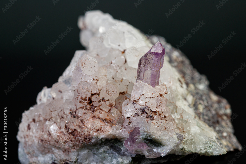 macro mineral amethyst stone in rock on a black background macro mineral amethyst stone in rock on a black background