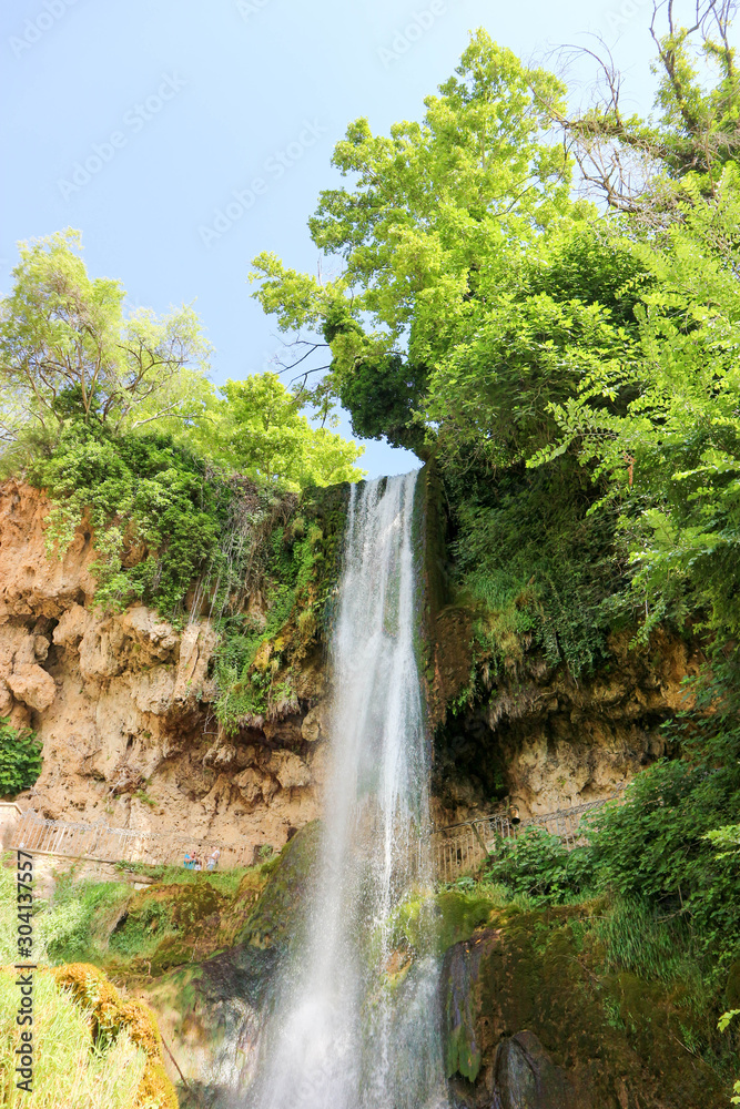 Scenic view of famous Edessa waterfall surrounded by green trees, Greece