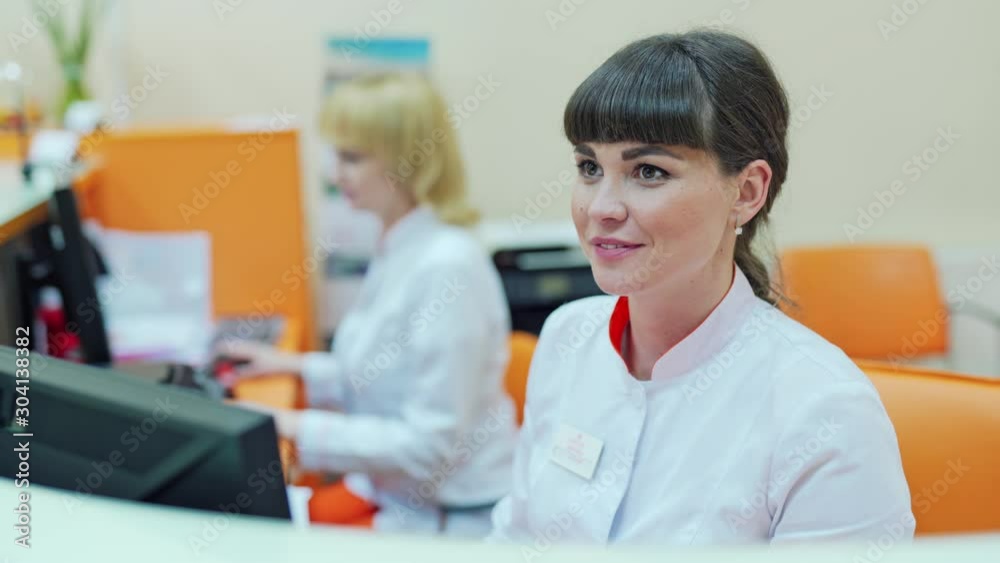 Female receptionist in hospital. Smiling female receptionist at the reception desk