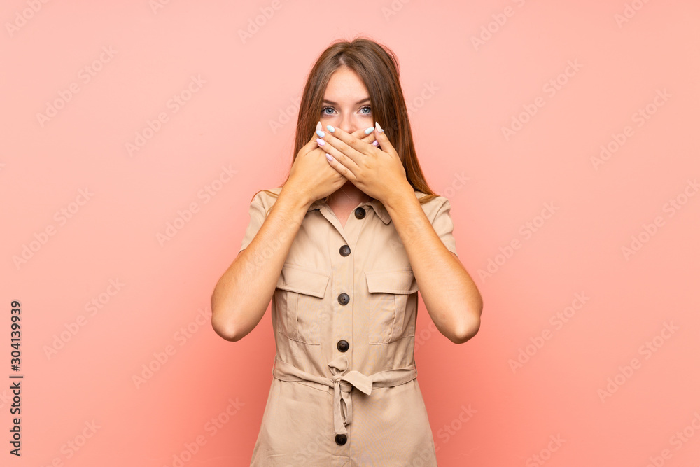 Lithuanian blonde girl over isolated pink background covering mouth with hands Lithuanian blonde girl over isolated pink background covering mouth with hands