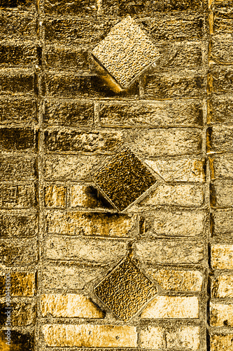 Golden background based on the image of a brick wall tinted in gold