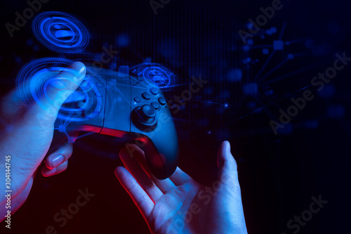 gamer boy with hand holding the joystick controller electronic for playing game with online network connection  technology device in esport tournament challenge concept