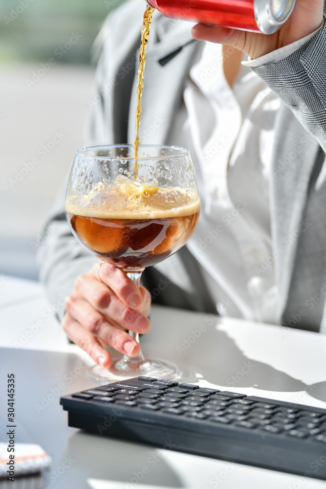 Close-up working woman it is served a coke Close-up working woman it is served a coke