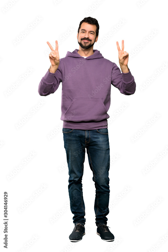 Full-length shot of Handsome man with sweatshirt showing victory sign with both hands over isolated white background Full-length shot of Handsome man with sweatshirt showing victory sign with both hands over isolated white background