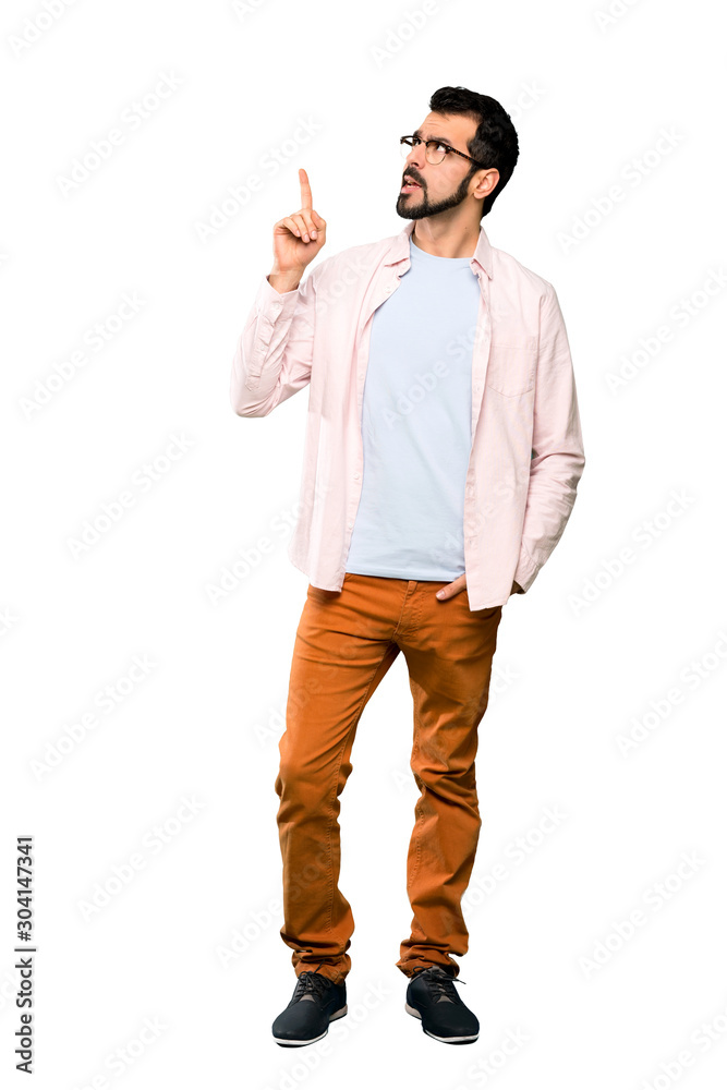 Full-length shot of Handsome man with beard thinking an idea pointing the finger up over isolated white background Full-length shot of Handsome man with beard thinking an idea pointing the finger up over isolated white background
