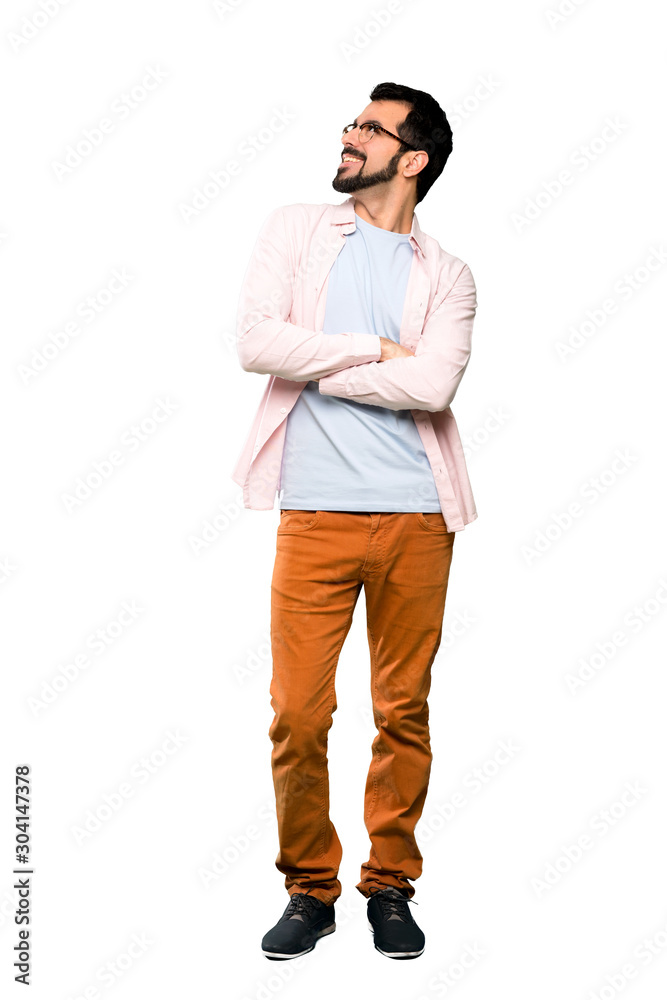 Full-length shot of Handsome man with beard looking up while smiling over isolated white background Full-length shot of Handsome man with beard looking up while smiling over isolated white background