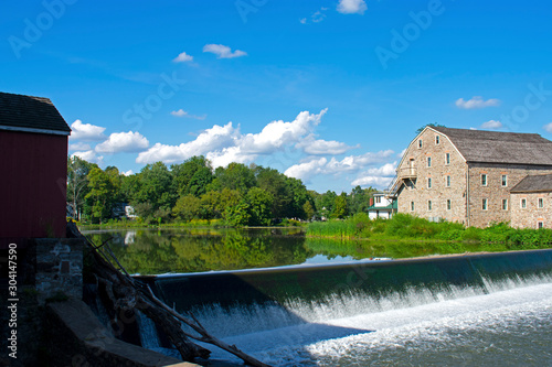 Scenic view of the exterior of the Hunterdon Art Museum in Clinton, New Jersey, on a sunny day, with a waterfall in the foreground -03 photo