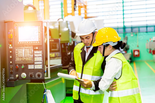 Businessman or engineers are training new employees In industrial plants that have machines and injection molds. The concept of welcoming new employees, teaching, training